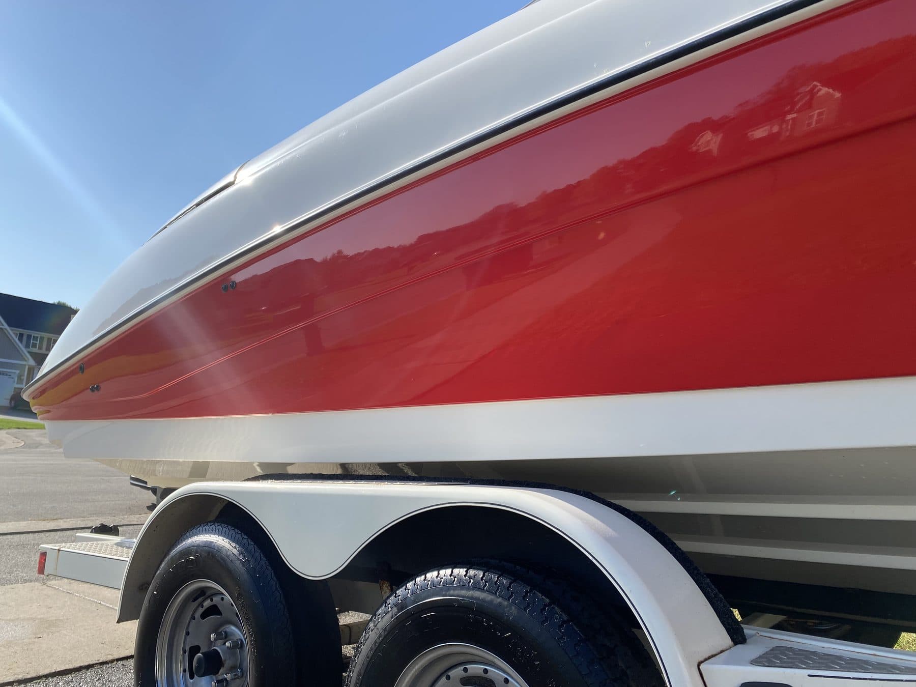 Bow of a red and white Cobalt, paint reflecting