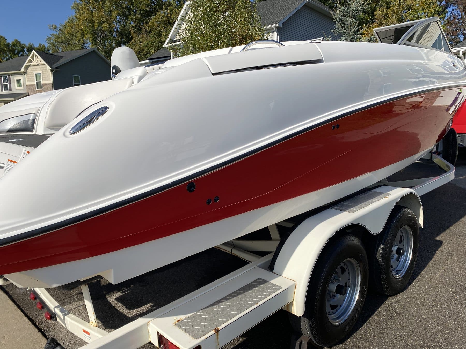 Red and white Cobalt boat gleaming on a trailer