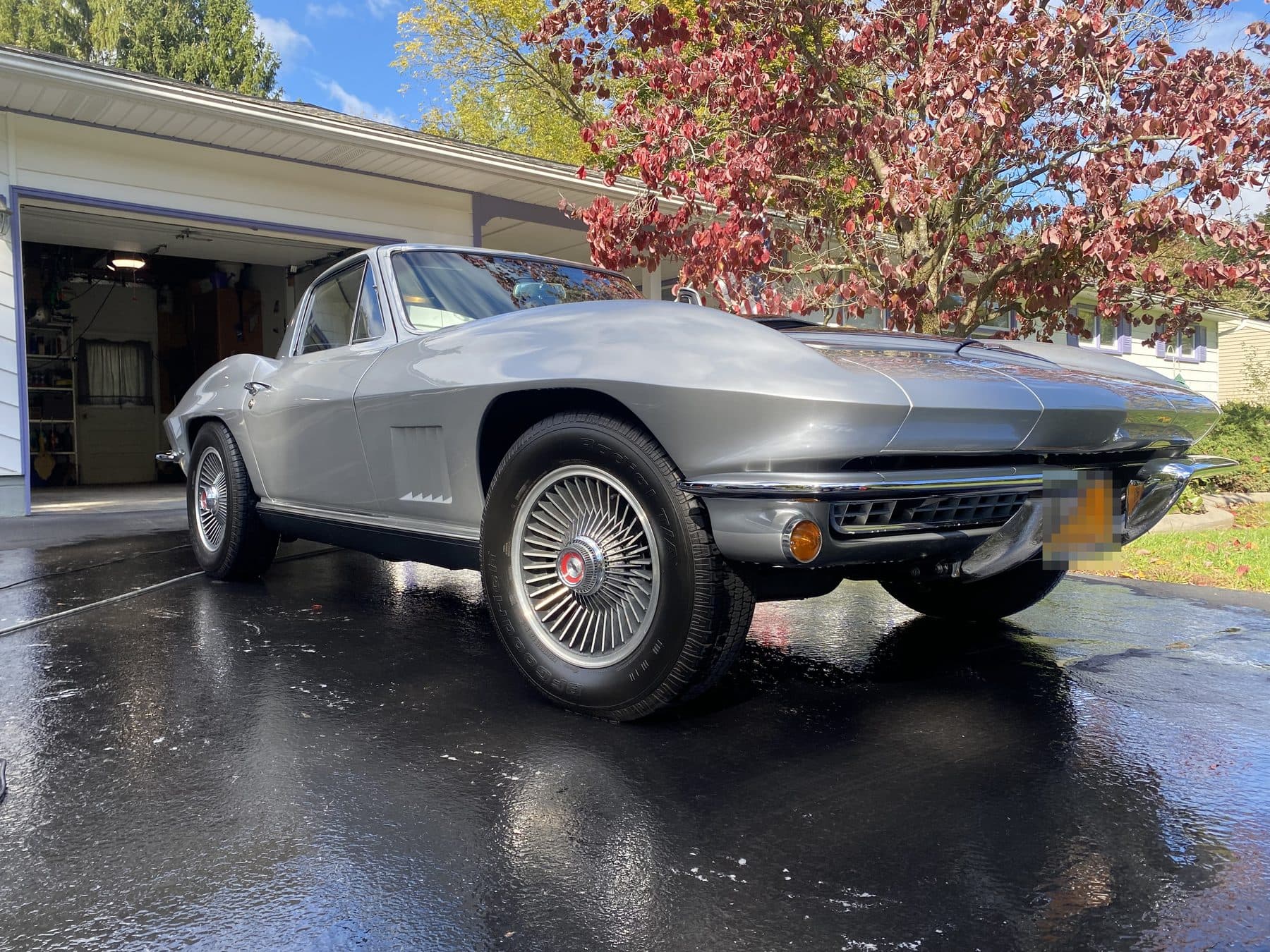 A classic Corvette washed and gleaming in a driveway