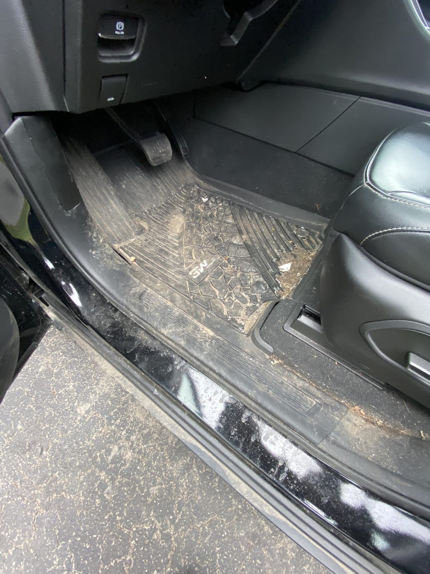 Door sill and mat caked in salt and grit