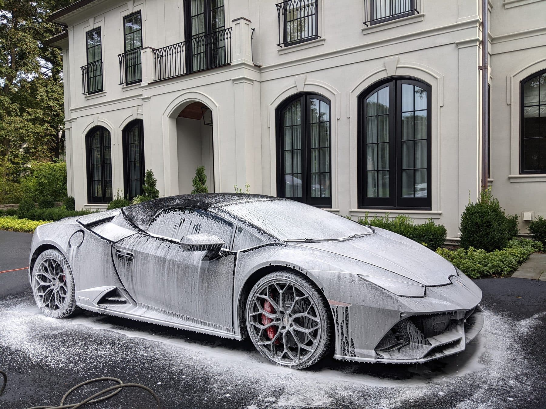 Lamborghini Huracan in profile, covered in snow foam