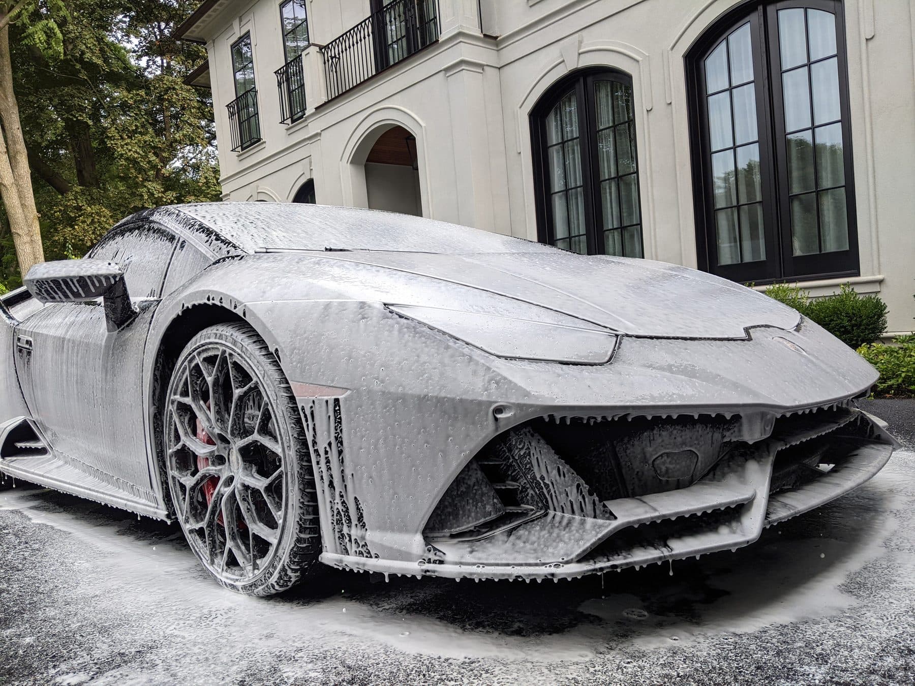 Lamborghini Huracan under a full coat of snow foam