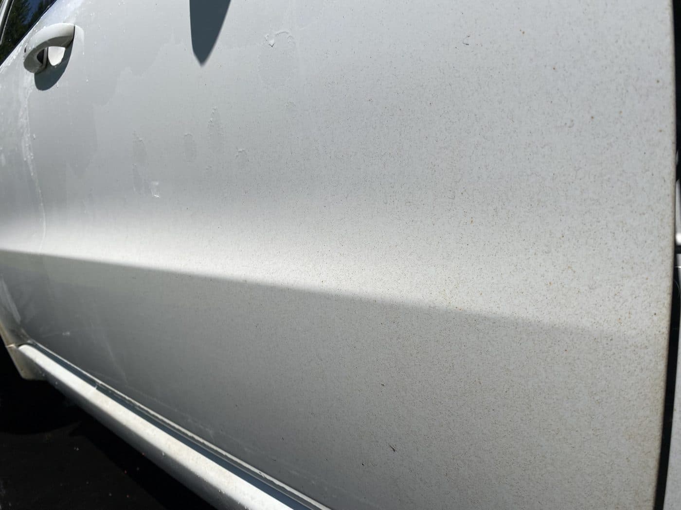 Silver car door before decontamination